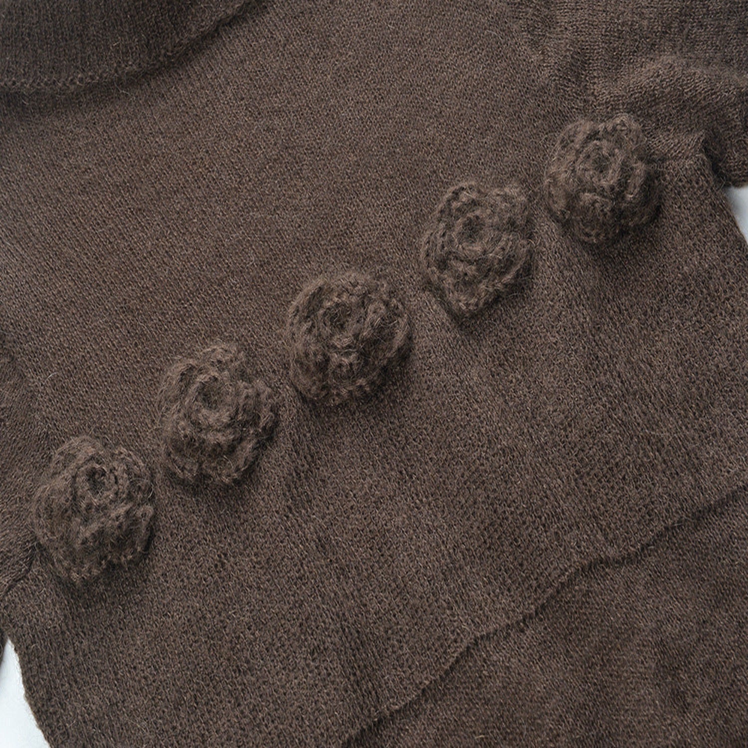 Brown fabric with floral patterns and a textured surface