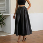 Person wearing a black leather skirt in an outdoor setting