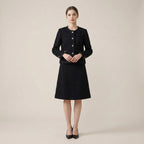Woman wearing a black coat and skirt set on a beige background