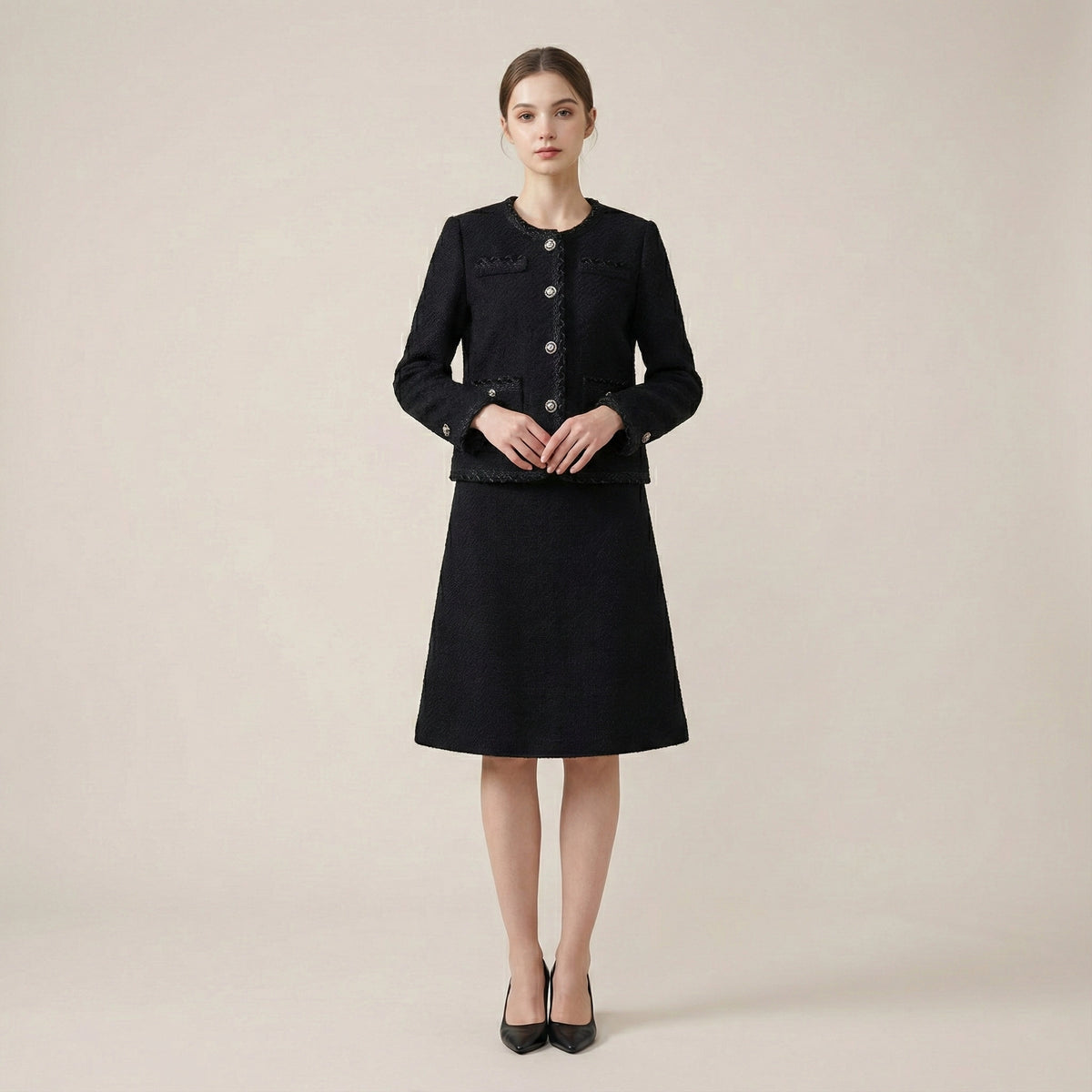 Woman wearing a black coat and skirt set on a beige background