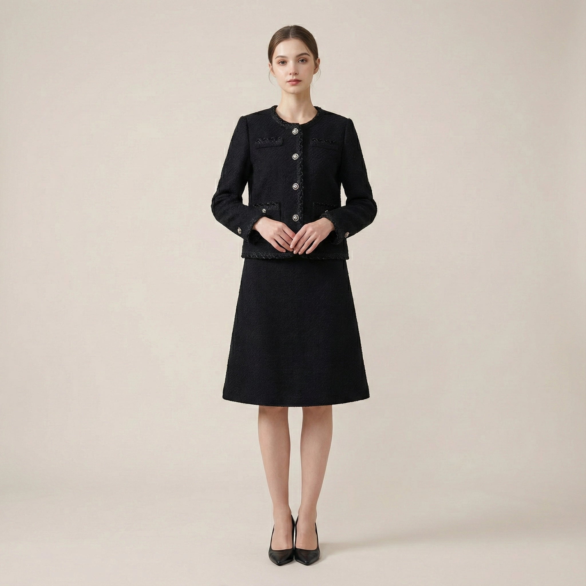 Woman wearing a black coat and skirt set on a beige background