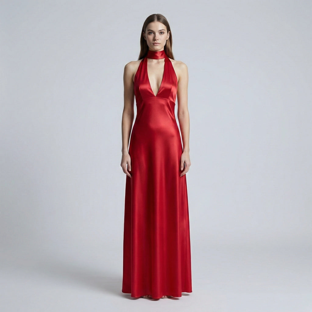 Woman wearing a red evening gown on a plain background