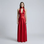 Woman wearing a red evening gown on a plain background