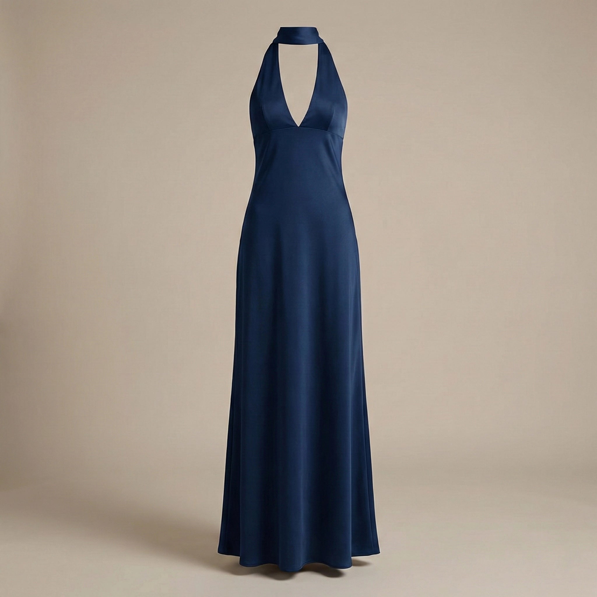 Navy blue halter neck gown on a beige background