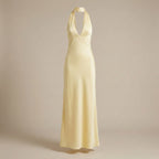 Yellow halter neck dress on a beige background