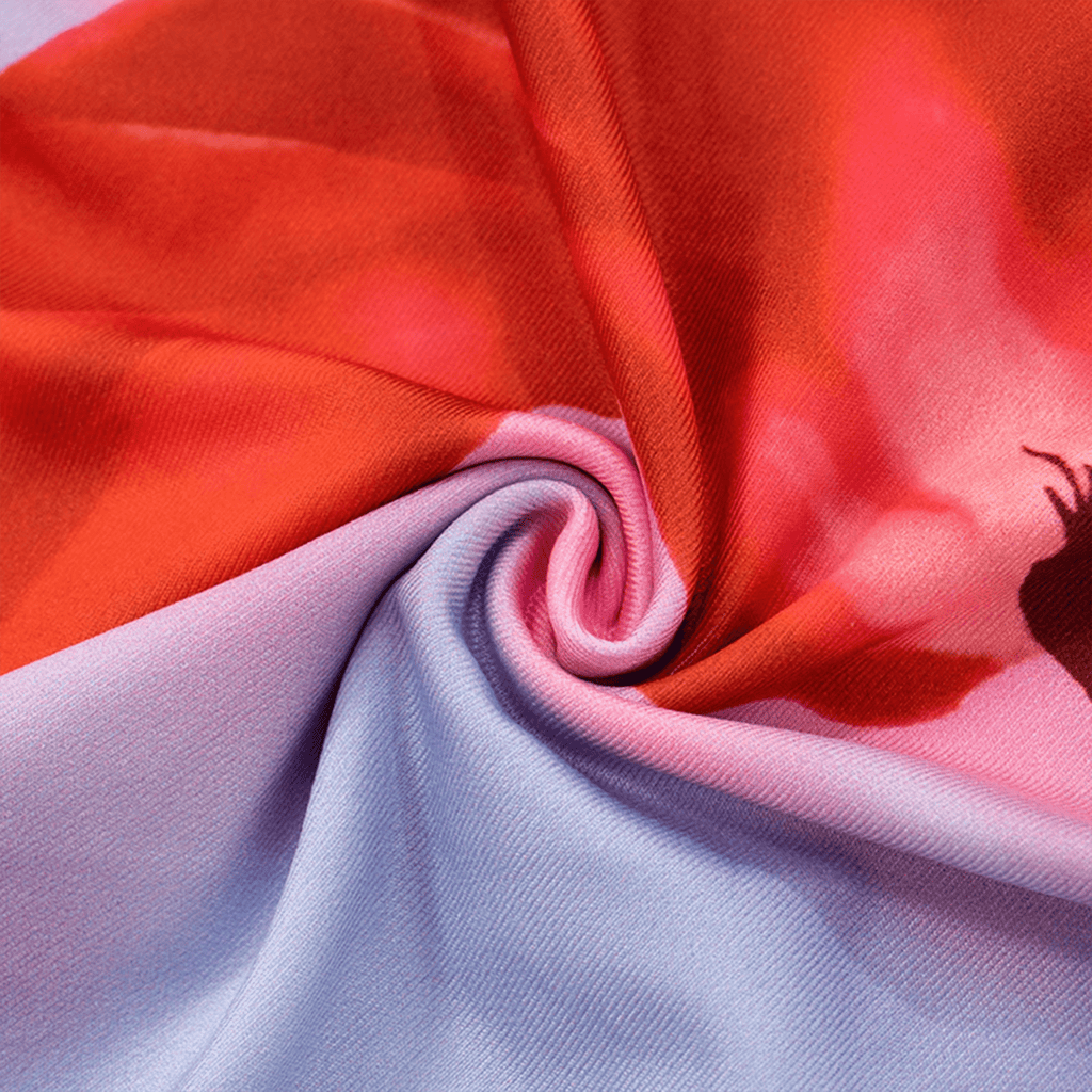 Close-up of colorful fabric with red, pink, and light blue colors.