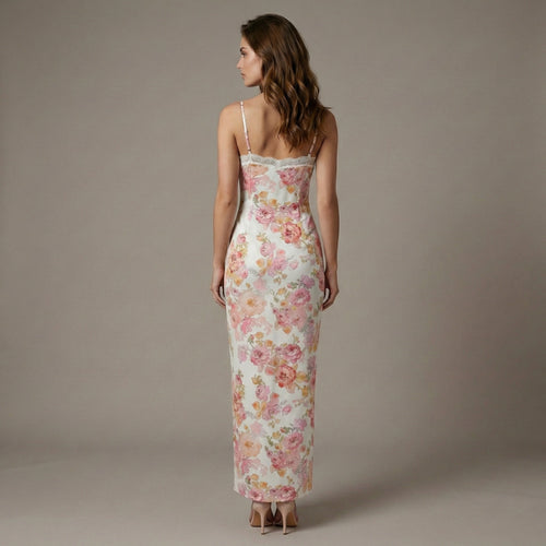 Woman wearing a floral dress against a plain background