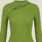 Green ribbed sweater on a beige background