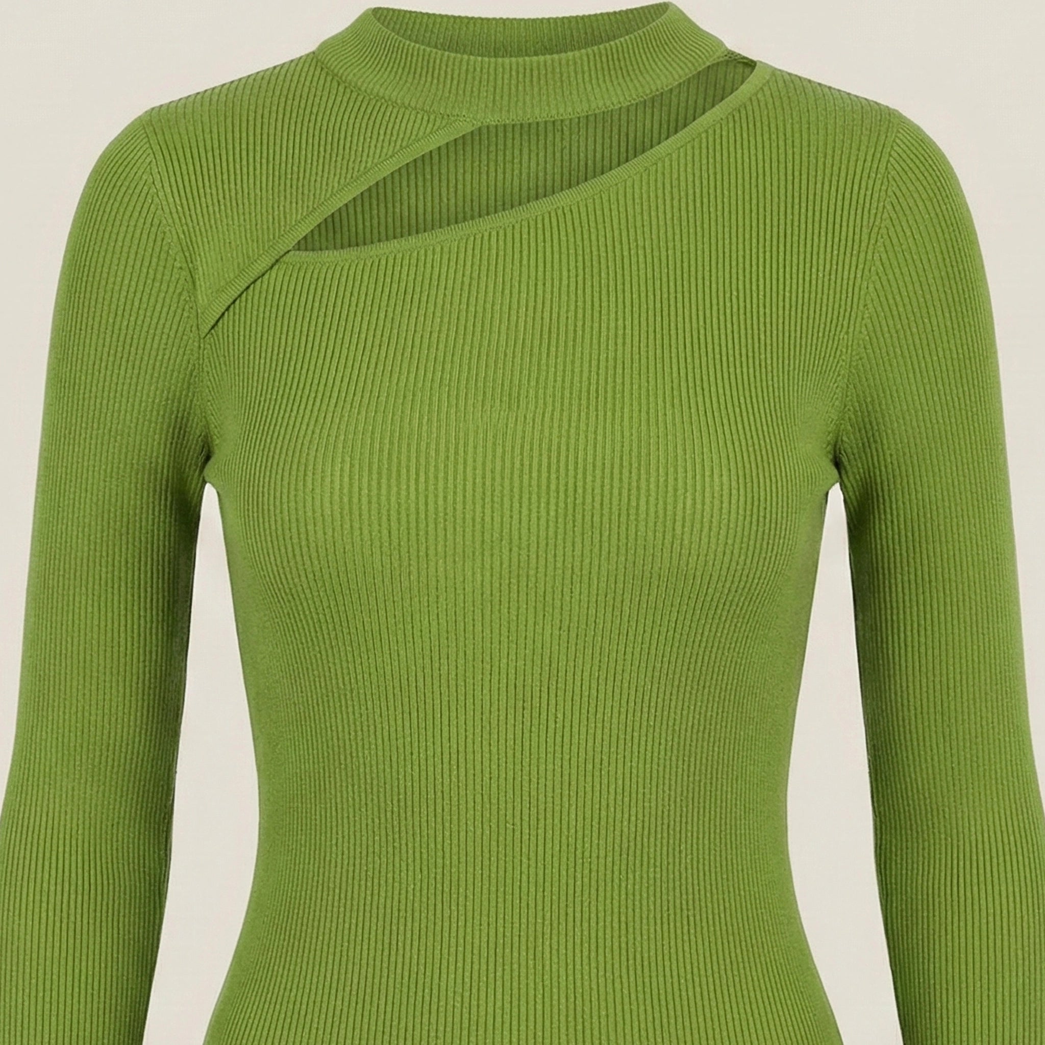 Green ribbed sweater on a beige background