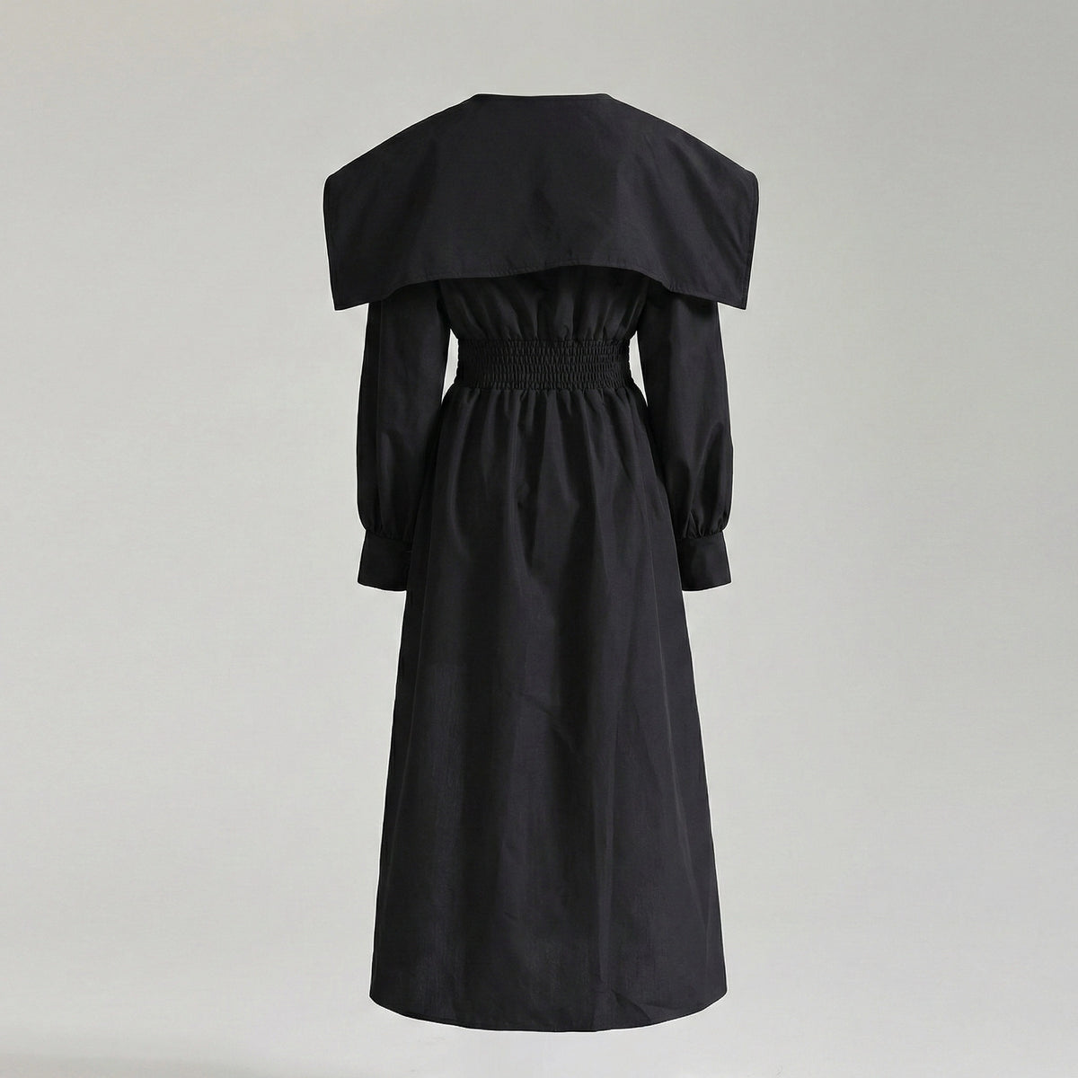 Black off-shoulder dress on a light gray background