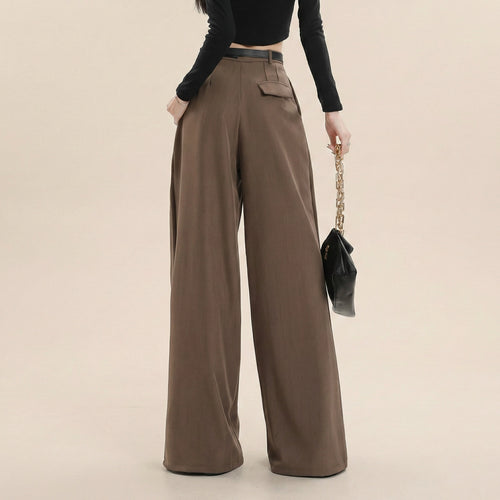 Brown wide-leg pants worn by a person on a beige background