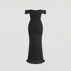 Black off-shoulder dress on a light gray background