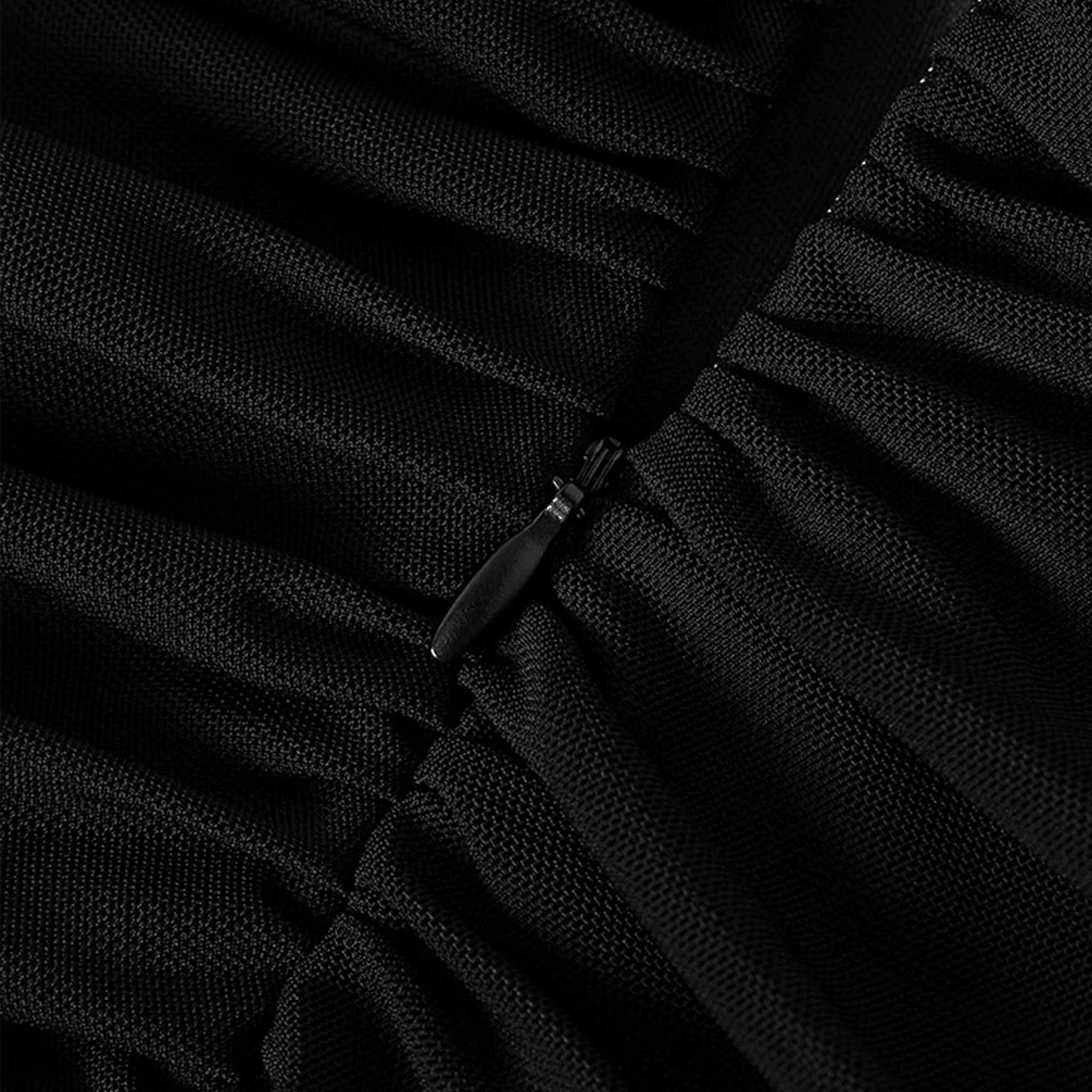 Close-up of a black dress with a zipper detail
