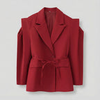 Red blazer with shoulder straps on a light gray background