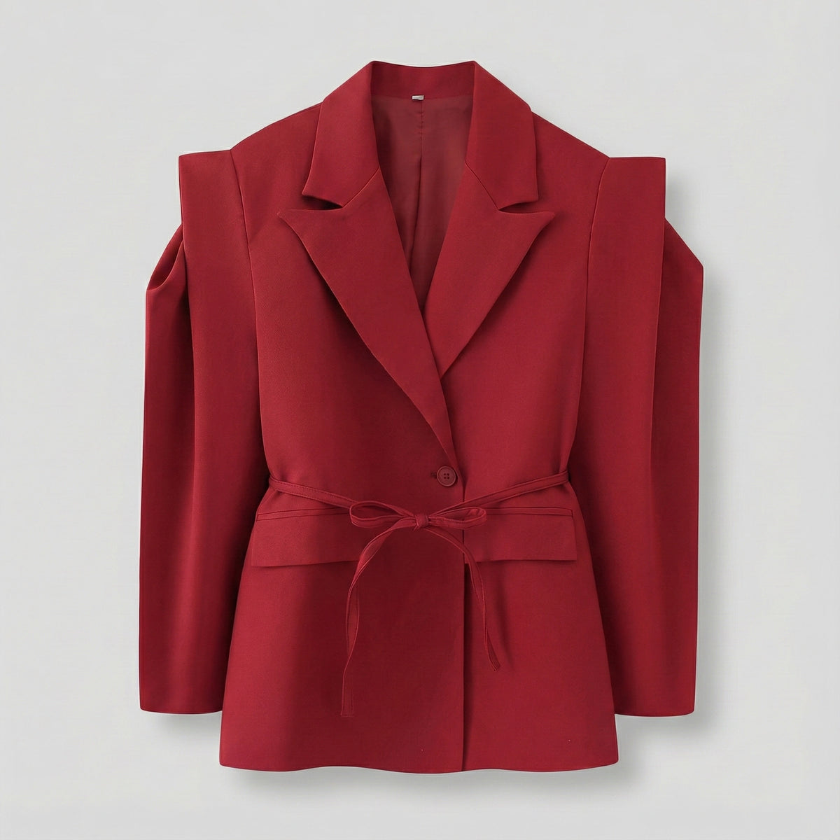 Red blazer with shoulder straps on a light gray background