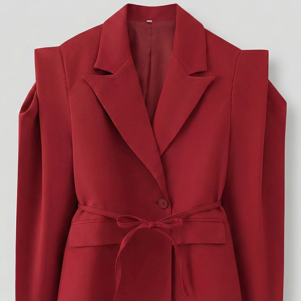 Red coat with shoulder cutouts on a light gray background