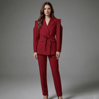 Woman wearing a red suit against a gray background