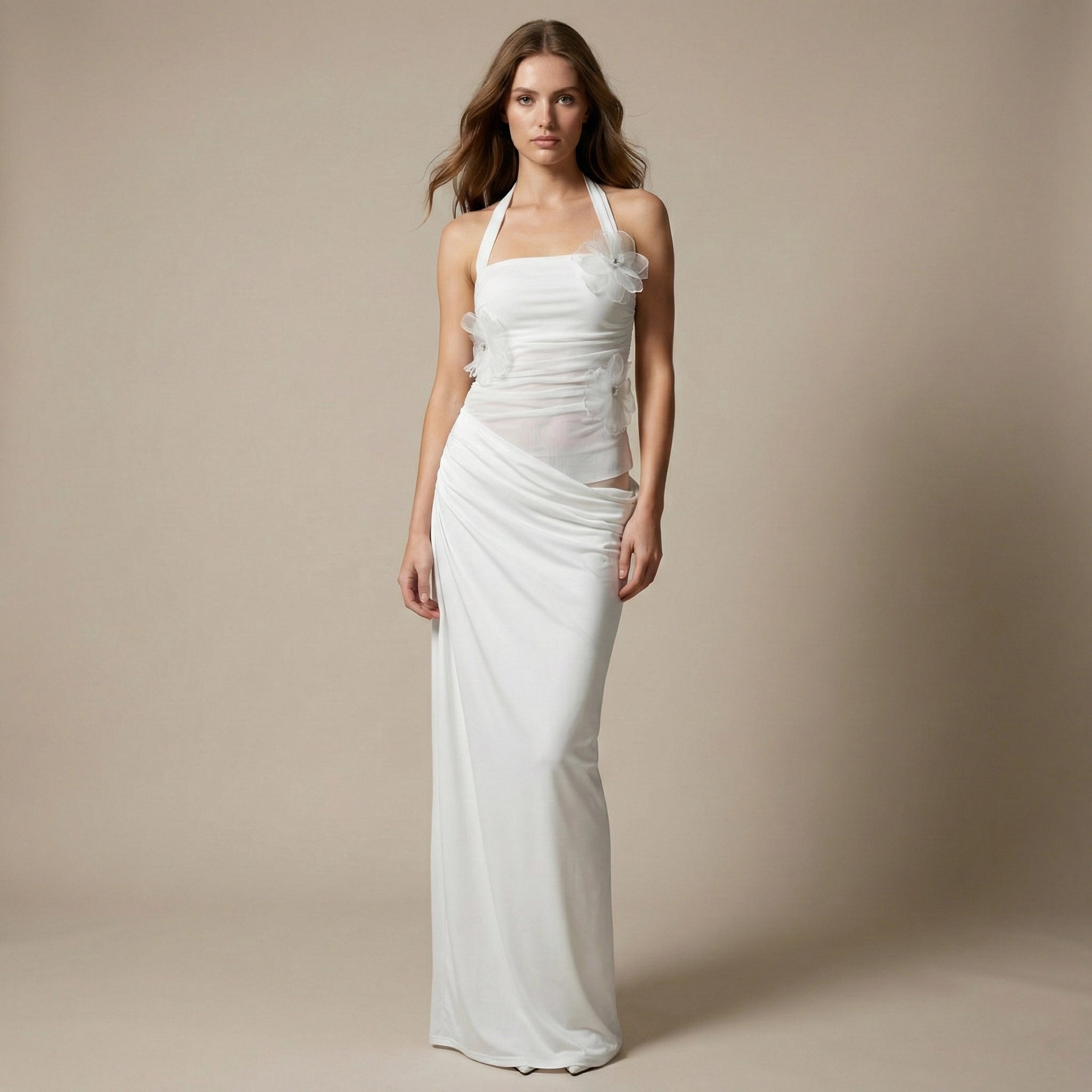 Woman wearing a white halter neck gown against a beige background