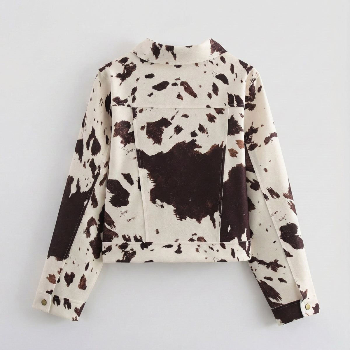 Cow print jacket on a light gray background