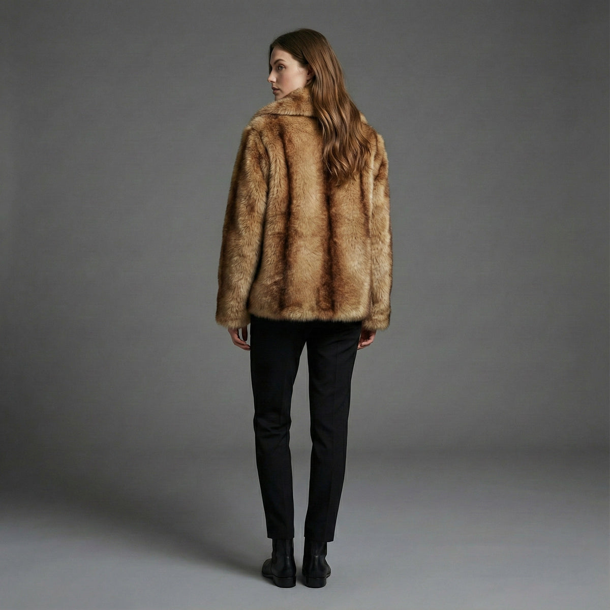 Person wearing a brown fur coat against a gray background