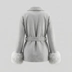 Gray coat with fur cuffs on a light gray background