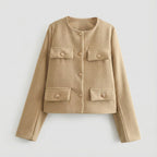 Beige jacket with button details on a light gray background