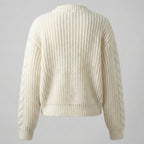 Beige knitted sweater on a gray background