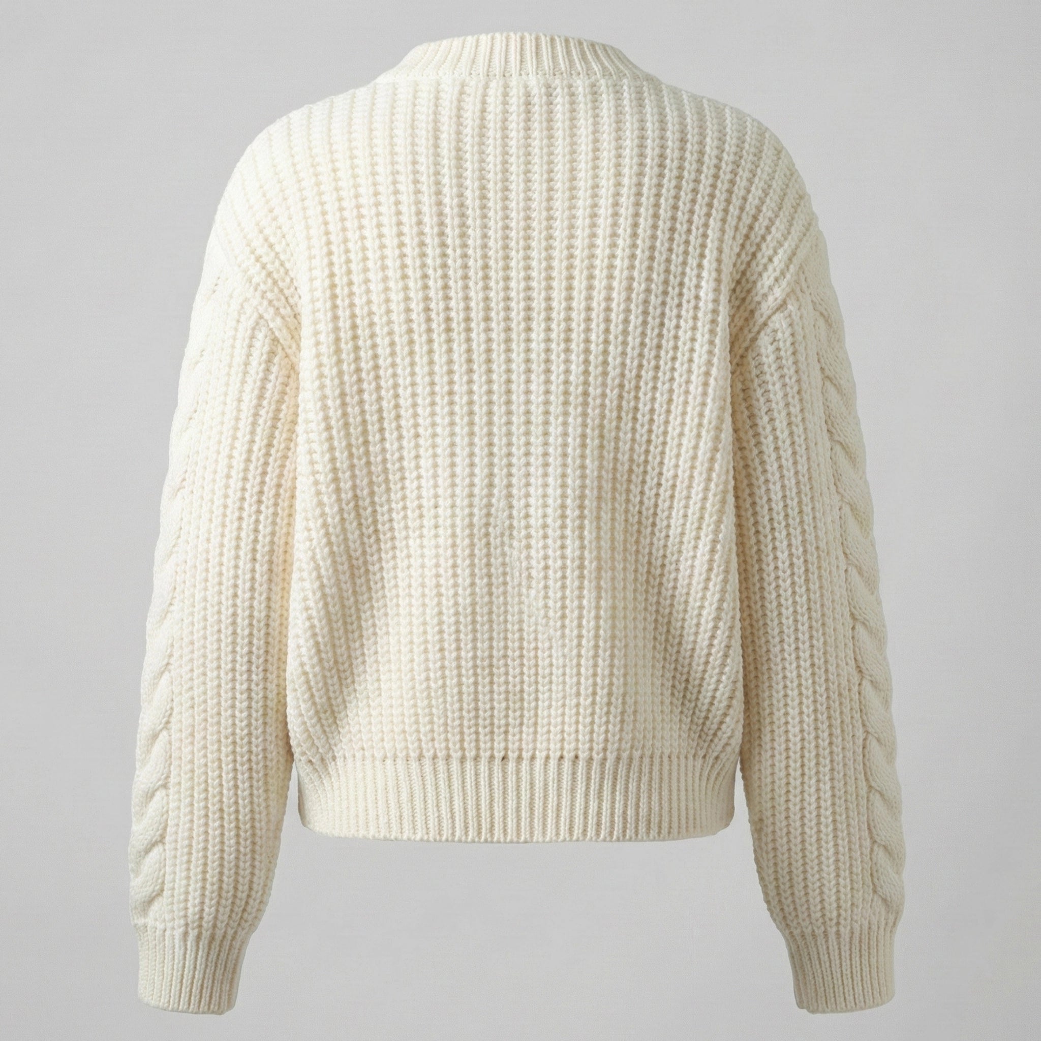 Beige knitted sweater on a gray background