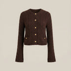Brown cable knit cardigan with gold buttons on a beige background