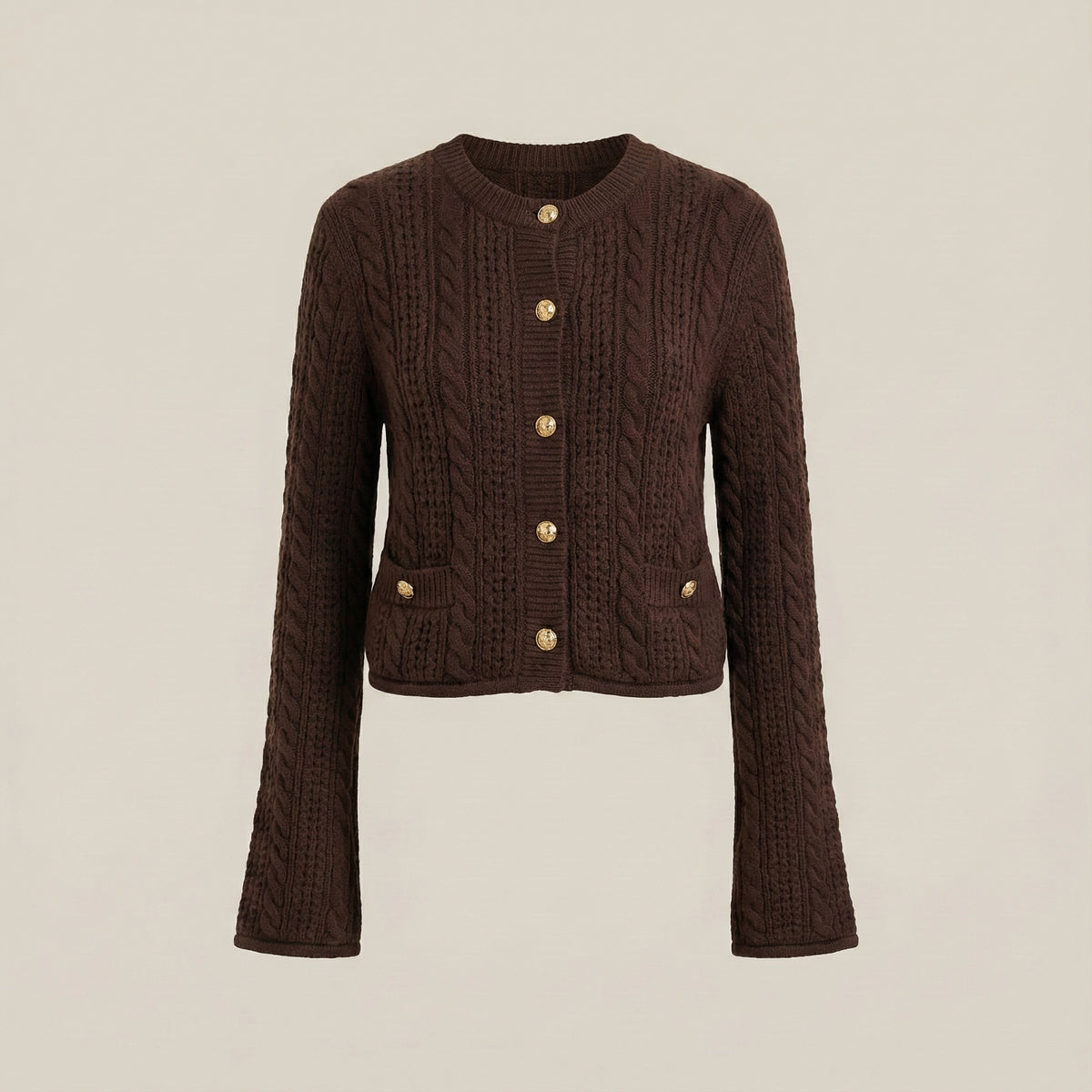 Brown cable knit cardigan with gold buttons on a beige background