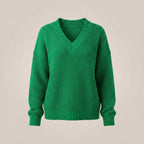 Green sweater on a beige background