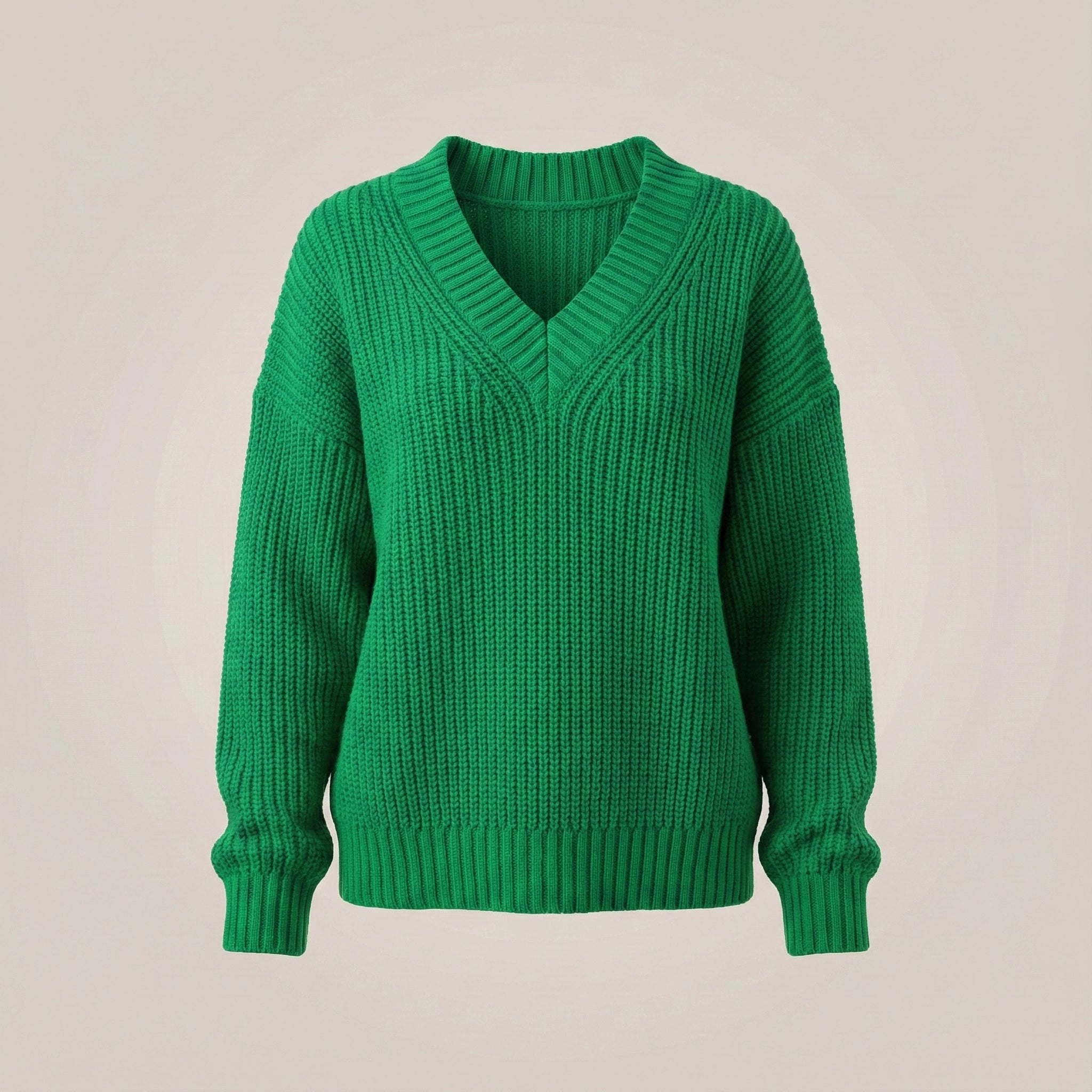 Green sweater on a beige background