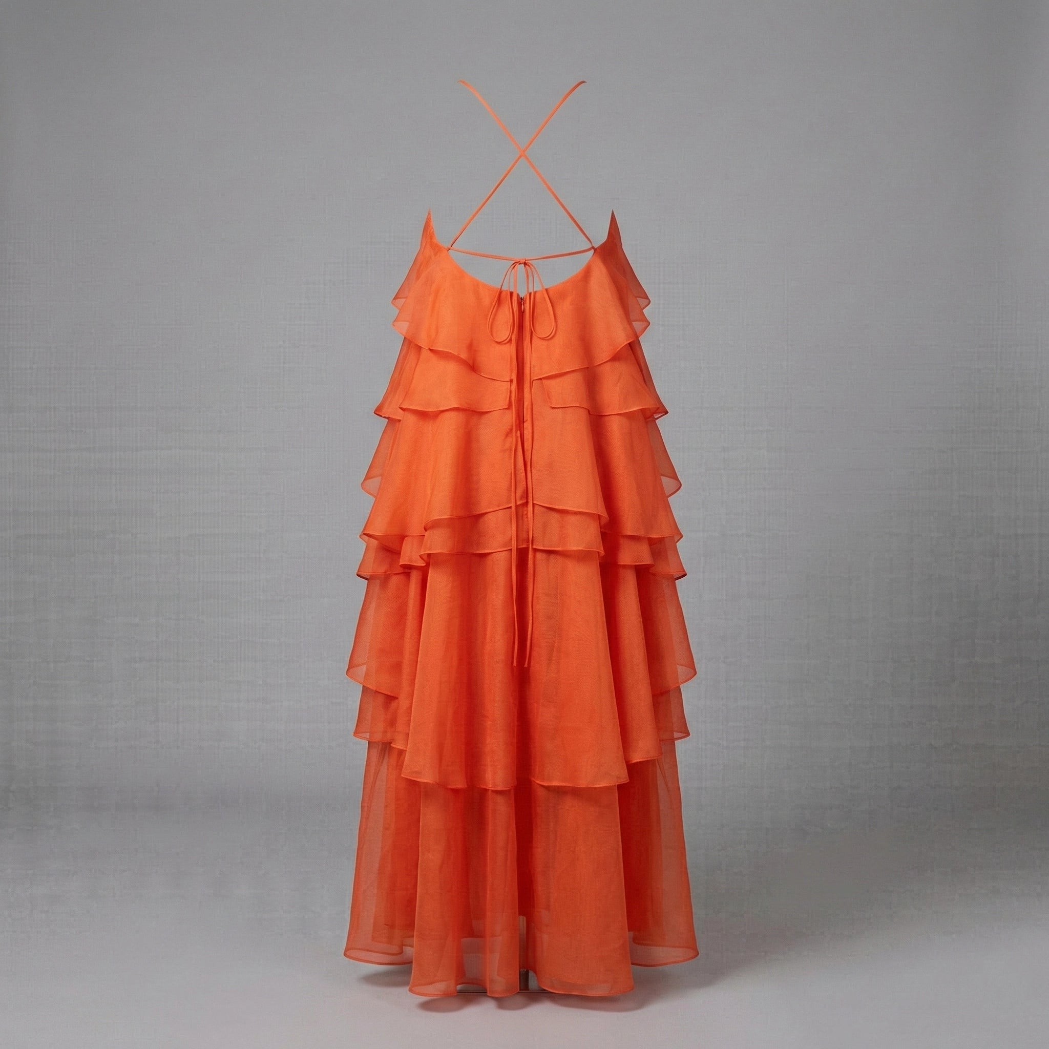 Orange tiered dress on a gray background