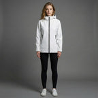 Woman wearing a white jacket on a gray background
