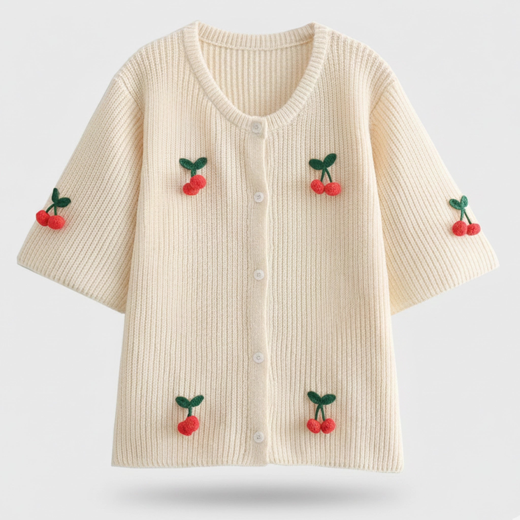 Beige sweater with cherry decorations on a light gray background