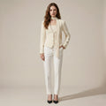 Woman wearing a cream-colored suit with a white background