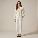 Woman wearing a cream-colored suit with a white background