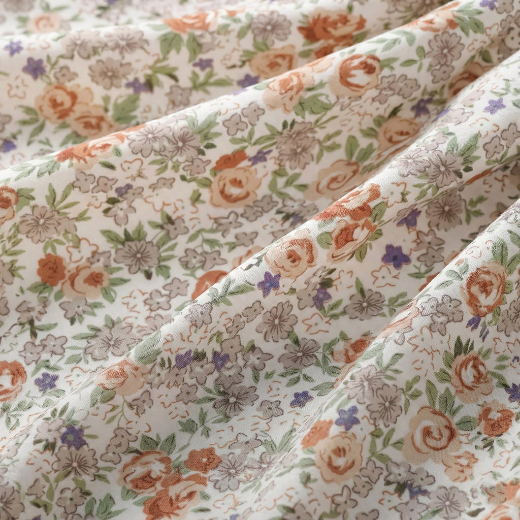 Floral fabric with orange and purple flowers on a white background