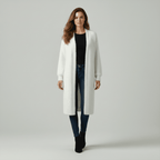 Woman wearing a white long coat on a gray background
