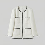 White textured jacket with black trim on a light gray background