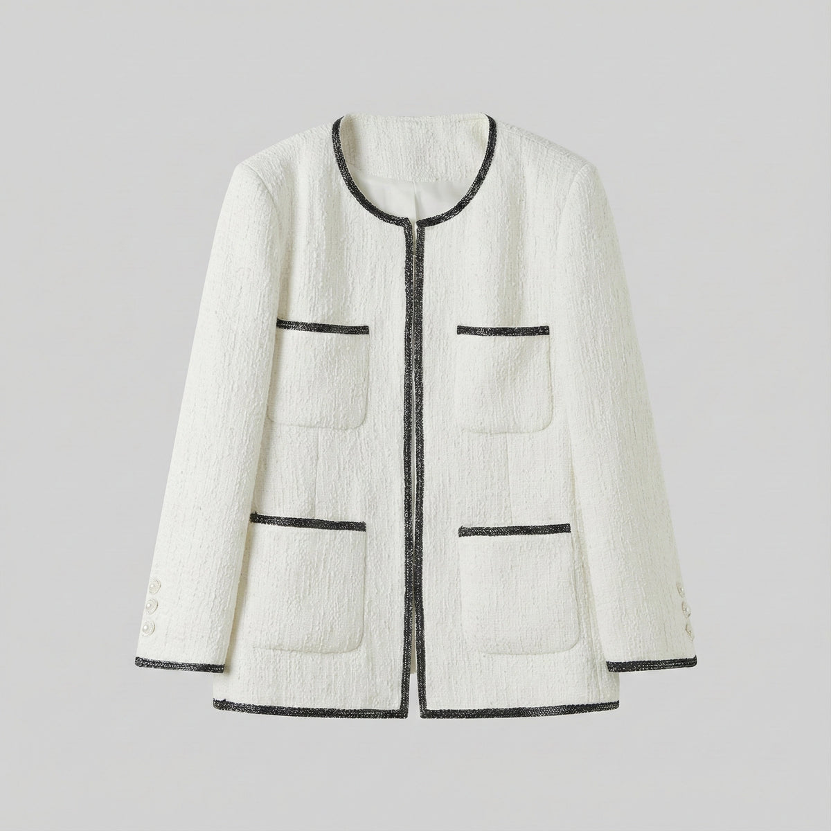 White textured jacket with black trim on a light gray background