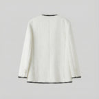 White textured jacket with black trim on a light gray background