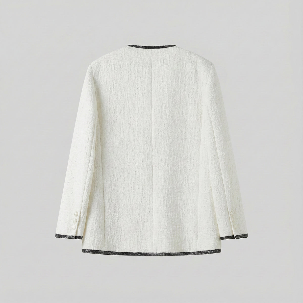 White textured jacket with black trim on a light gray background