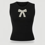 Black sleeveless top with a decorative bow on a light gray background