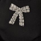 Decorative brooch with intricate design on a black background