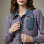 Person wearing a purple knit cardigan with denim collar and buttons.