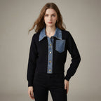 Woman wearing a black sweater with denim collar and buttons on a beige background