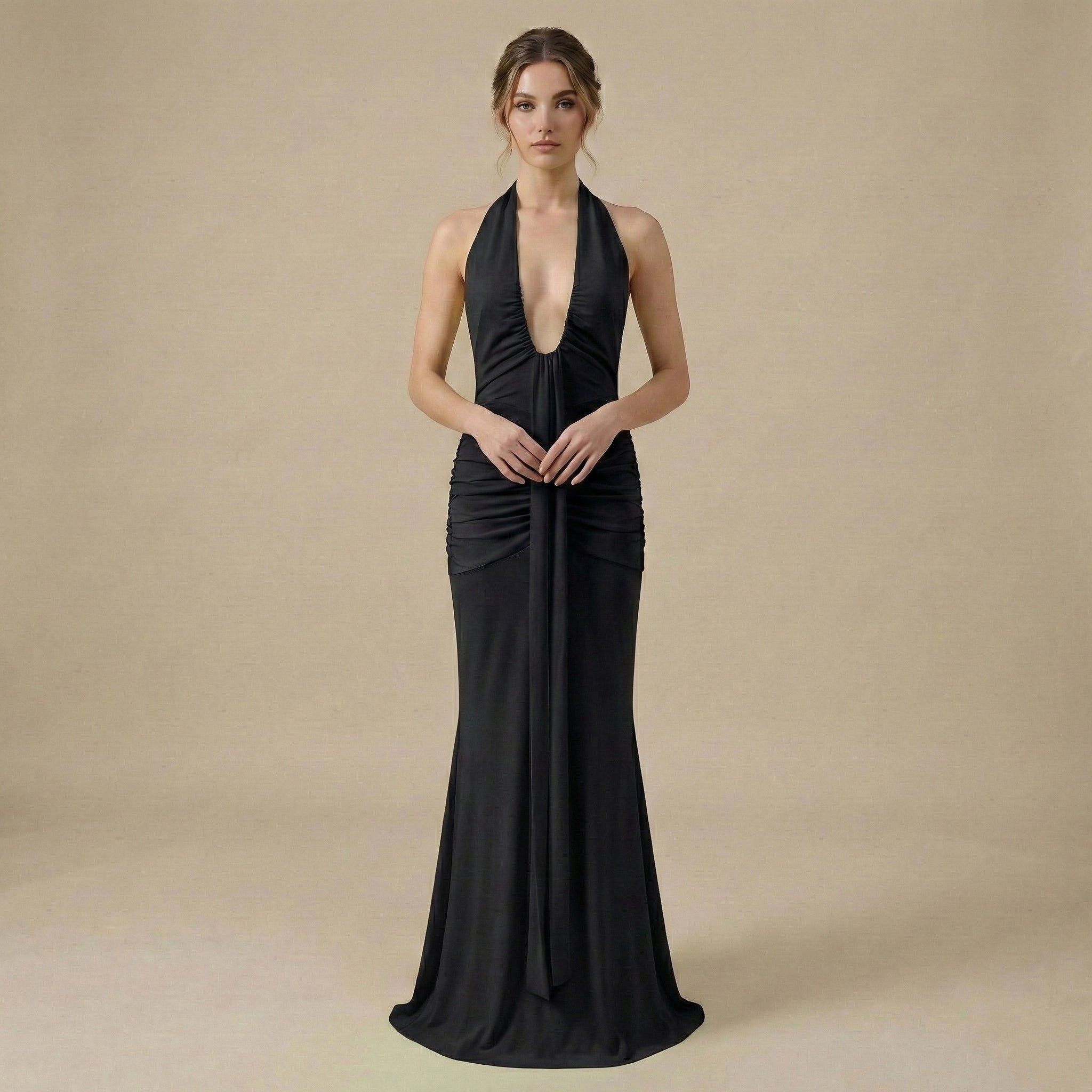 Woman wearing a black halter neck gown on a beige background