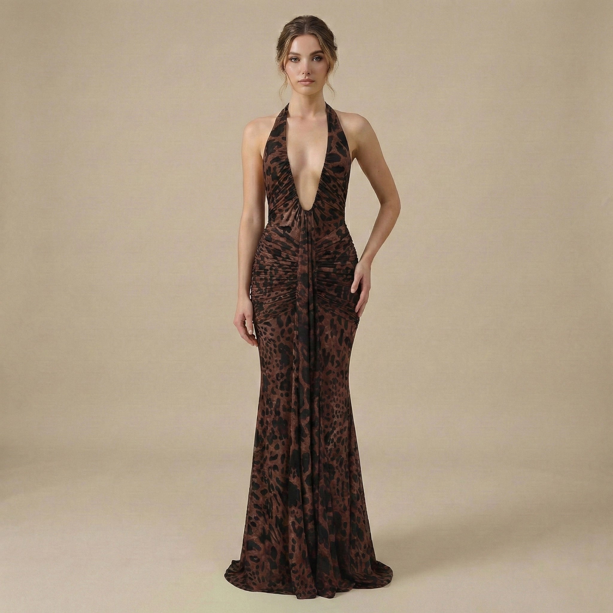 Woman wearing a leopard print halter neck gown on a beige background
