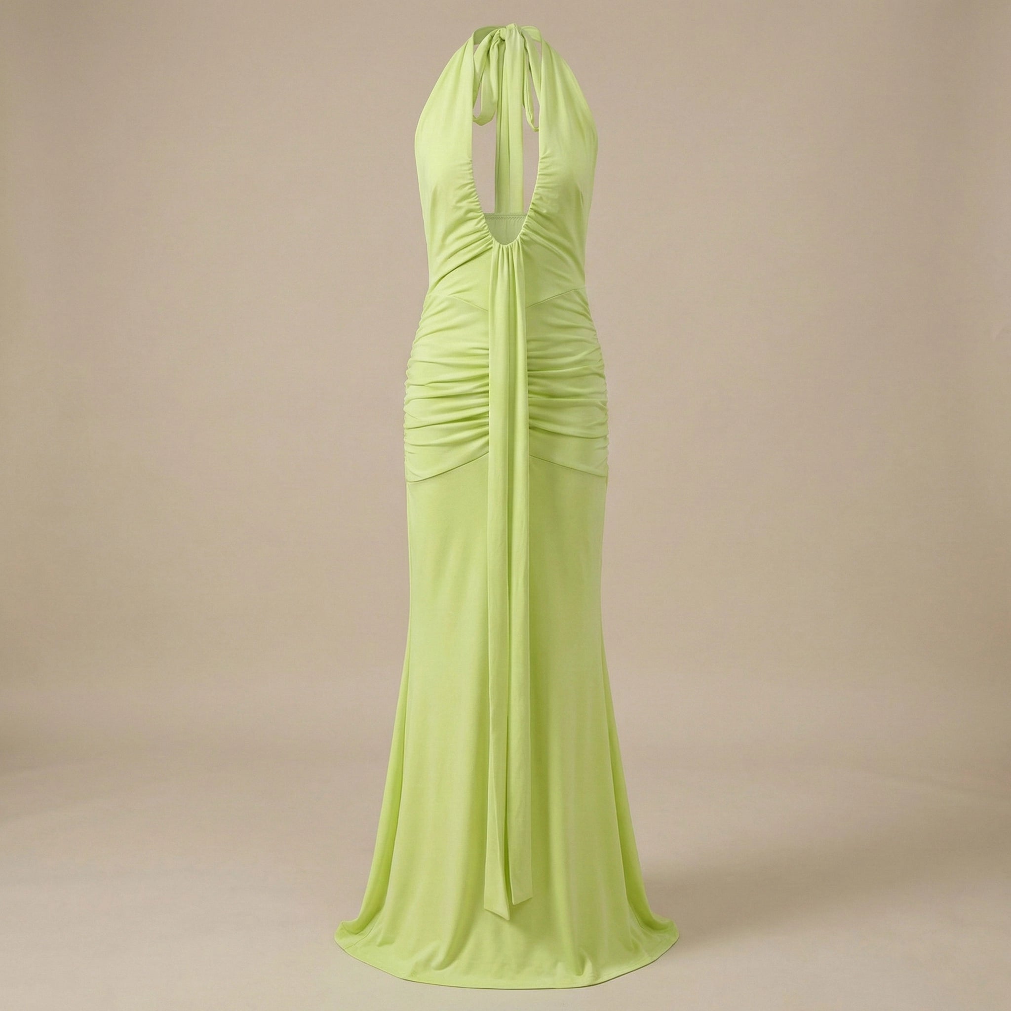 Lime green halter neck gown on a beige background